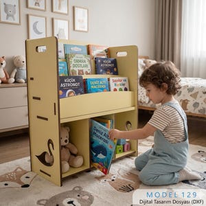 Puede incluir: Una estantería de madera amarilla clara con múltiples estantes, que contiene libros infantiles coloridos. La estantería tiene recortes de cisnes en los lados. Un niño está buscando un libro. El texto "MODEL 129 Dijital Tasarım Dosyası (DXF)" está en la parte inferior.