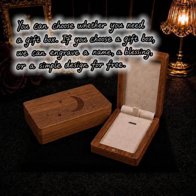 May include: Two wooden jewelry boxes, one closed and one open, displayed on a dark surface. The closed box features a crescent moon and star design. The open box reveals a beige interior with a small holder. Text on the image says engraving is free.