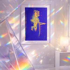 Op de afbeelding: Een ingelijst kunstwerk met een blauwe achtergrond en een kleurrijke, abstracte menselijke figuur. De tekst "FAIL EPIC" is verticaal rechts uitgelijnd. De kamer is wit met een bank en een lamp.
