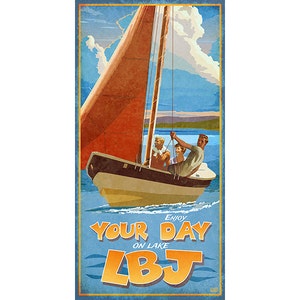 May include: Vintage-style poster featuring a sailboat on a lake with three people aboard. The boat has a brown hull, a tan sail, and is set against a blue sky with clouds. Text reads "Enjoy Your Day on Lake LBJ."
