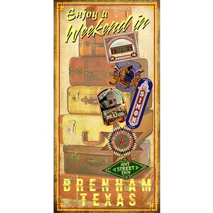 May include: A vintage-style poster advertising a weekend in Brenham, Texas. The poster features a stack of old suitcases with various travel-themed stickers and the text "Enjoy a Weekend in Brenham Texas".