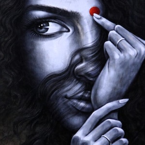 May include: A grayscale portrait of a person with dark, curly hair. A red dot is on the forehead. The person's fingers touch the dot and their face. A silver ring is on one finger. The image is a close-up of the face and hands.