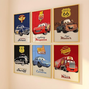 May include: A set of six framed wall art prints featuring characters from the movie Cars, including Hudson Hornet, Lightning McQueen, Tow Mater, Sheriff, Sally Carrera, and Team Hauler Mack, each with their name and a specific logo.