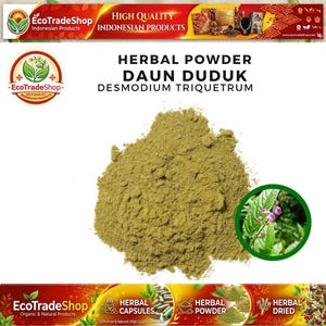 May include: A pile of light olive green herbal powder labeled as Daun Duduk Desmodium Triquetrum. The text Herbal Powder Daun Duduk Desmodium Triquetrum is printed above the powder, with a circular inset showing the green plant with small flowers.