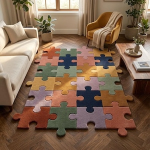 May include: A colorful puzzle-piece rug in a living room setting. The rug features various colors, including orange, green, blue, and yellow. The rug is placed on a wooden floor, with a sofa, armchair, and coffee table in the background.