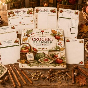 May include: A crochet planner set featuring a central planner book, multiple tracking sheets, and various accessories including wooden crochet hooks, gold-toned stitch markers, scissors, yarn balls, and a mug, all decorated with autumn-themed apple motifs.