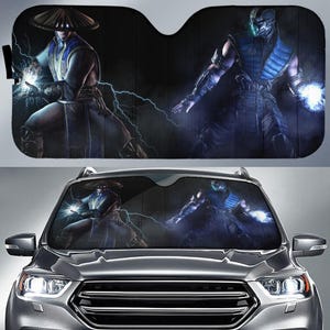 May include: Car windshield sunshade featuring two characters from a video game. One character is in a blue and white outfit with a straw hat, and the other is in a blue and black outfit. Both characters are surrounded by lightning.