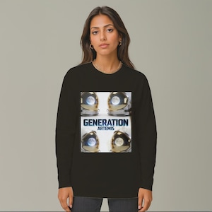 May include: Black long-sleeve shirt featuring a graphic with four astronaut helmets, each with a moon reflection. The text "GENERATION ARTEMIS" is displayed in white and blue. The shirt is a crew neck.