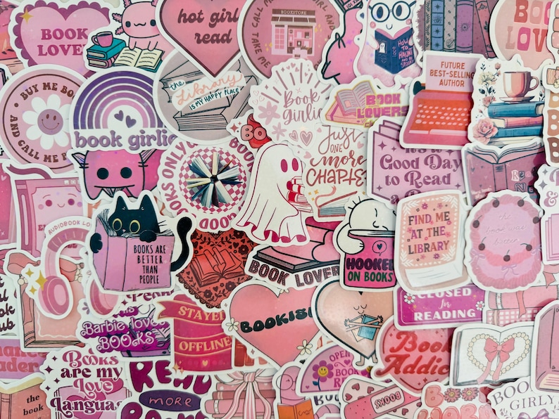May include: A selection of pink and purple stickers with book-related designs. The stickers display phrases such as "Book Lover," "Hot Girl Read," and "Find Me at the Library." Illustrations include books, hearts, and charming characters.