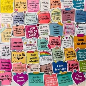 May include: A selection of brightly coloured sticky notes with motivational messages. The notes display phrases such as "I am fearless," "I can do this," and "Today is a great day!"