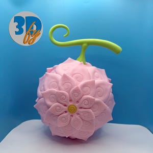 May include: A pink, spherical fruit with a flower-like design, featuring a green stem and a yellow center. The fruit has a detailed, textured surface and is set against a blue background. The logo "3D by" is visible in the upper left corner.