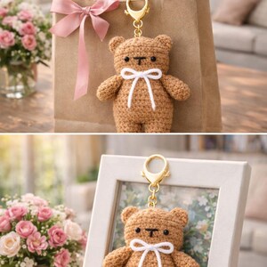May include: A crocheted brown teddy bear keyring with a white bow and gold-coloured clasp. The bear is attached to a brown paper gift bag with a pink ribbon. A framed photo and a bouquet of pink roses are also in the image.