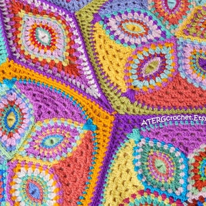 May include: A colorful crochet blanket with a geometric pattern featuring various shades of pink, purple, blue, green, yellow, and orange. The blanket is made up of multiple squares with intricate designs.