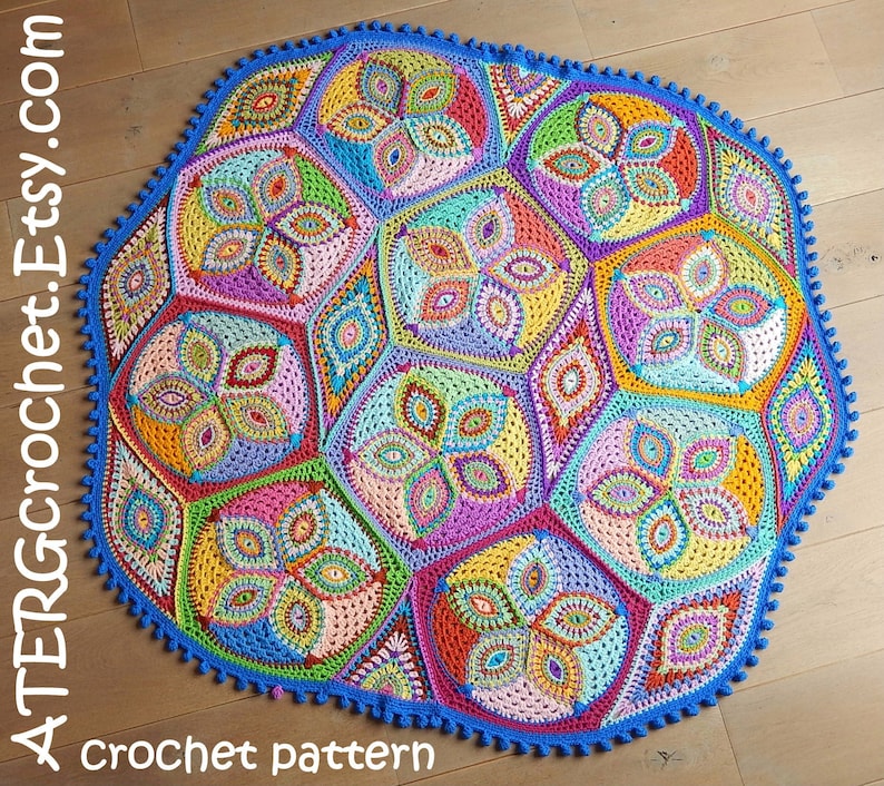 May include: A colorful crochet blanket with a geometric pattern. The blanket is made up of multiple hexagonal shapes with a variety of colors, including pink, blue, green, yellow, and orange. The blanket is edged with a blue crocheted border.
