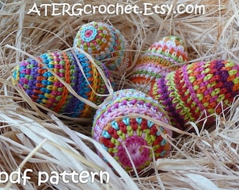 May include: Five colourful crocheted Easter eggs in a nest of straw. The eggs are decorated with different patterns and colours, including pink, green, orange, yellow, and blue. The text "ATERGcrochet.Etsy.com" and "pdf pattern" are visible in the image.
