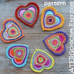 May include: Six crocheted hearts in various colors, including red, orange, yellow, green, blue, and purple. Each heart has a circular pattern in the center and is made with a variety of colorful yarns.