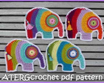 May include: Four colorful crocheted elephant ornaments with white trim and tassels. The elephants are arranged on a wooden surface. ATERGcrochet pdf pattern.