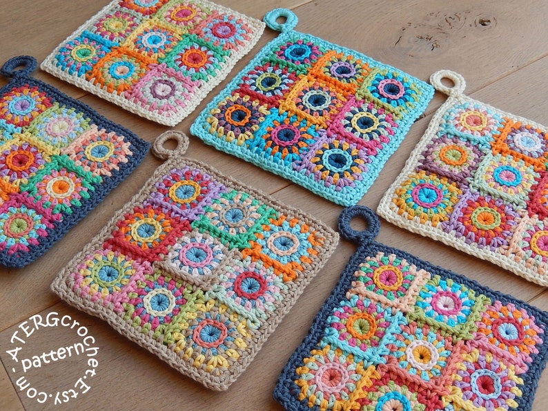 May include: Six crocheted pot holders in various colors including blue, green, orange, pink, red, and yellow. The pot holders are made of a square patchwork design with a circular pattern in the center of each square. The pot holders have a loop handle on one side. The pot holders are arranged in a row on a wooden surface. The text 'Easy Crochet Pattern' is visible in the lower left corner of the image.