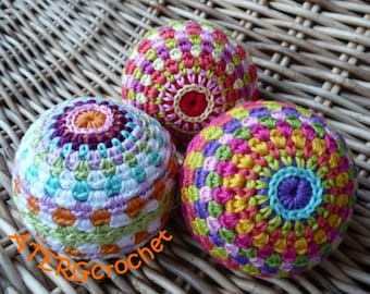 May include: Three colorful crocheted balls with different patterns and colors. The balls are made with a variety of yarn colors, including pink, purple, green, yellow, orange, and white.
