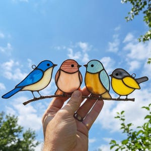 May include: A white ceramic mug with a black handle and the text "But First, Coffee" in a black, bold font. The mug is sitting on a white surface.