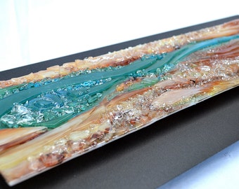 May include: A rectangular art piece depicting a river scene. The artwork features a turquoise river flowing through a landscape of tan, brown, and clear textured materials, creating a three-dimensional effect.