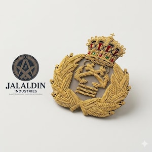 May include: A gold bullion embroidered badge featuring a crown atop a central emblem with two crossed anchors, surrounded by a wreath of laurel leaves. The crown includes red and green accents. The text JALALDIN INDUSTRIES is visible.