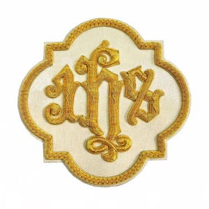 May include: Embroidered patch featuring a gold monogram on a cream-colored background. The monogram is intricately detailed with ornate, swirling letters. The patch has a decorative gold border, creating a classic and elegant design.