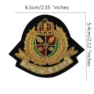 May include: Embroidered patch with a crown and shield design, measuring 2.55 inches wide and 2.12 inches high. The patch features gold, red, blue, and green colors, with the text "POMMAGOL" in gold.