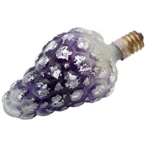 May include: A grape-shaped light bulb with a purple glass surface featuring a distressed silver finish. The bulb has a standard metallic screw base at the top, designed for insertion into a socket, with a textured, bumpy exterior resembling fruit.