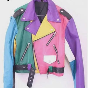 May include: A colorful, multi-panel jacket in a variety of colors, including pink, purple, yellow, green, and blue. The jacket has a classic biker style with a notched collar, asymmetrical zipper closure, and a belt at the waist. The text "Style 2" is in the upper left corner.