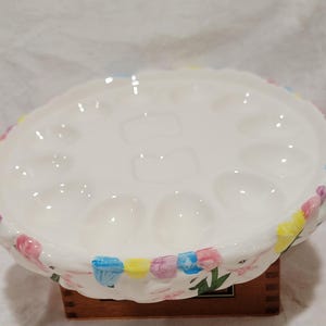 May include: A set of three ceramic mugs with a speckled, matte finish. The mugs are in shades of cream, light gray, and dark gray. Each mug has a simple, minimalist design, perfect for coffee or tea.