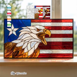 May include: Stained glass panel featuring an American flag design with a detailed eagle. The panel has a blue field with a white star, red and white stripes, and a brown, white, and yellow eagle. The text "By: QGcrafts" is at the bottom.