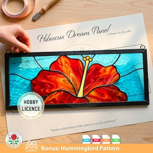 May include: A stained glass panel featuring a vibrant red and orange hibiscus flower against a turquoise background. The panel is framed in black and includes the text "Hibiscus Dream Panel" and "A Pattern by QGcrafts".