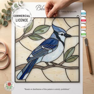May include: Stained glass pattern featuring a blue jay perched on a branch. The bird is rendered in shades of blue, white, and gray, with green leaves. The pattern includes the text "Commercial Licence" and "A Pattern by QGcrafts".