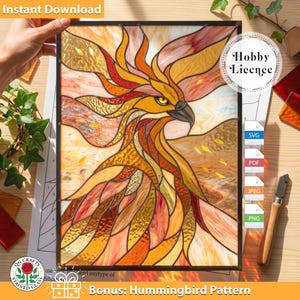 May include: A stained glass panel featuring a phoenix design in shades of orange, yellow, and brown. The artwork includes the text "Instant Download" and "Bonus: Hummingbird Pattern". The panel is held by a hand and includes a "Hobby License" badge.