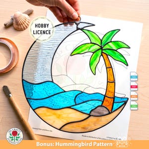 May include: Stained glass art piece depicting a tropical scene with a palm tree, ocean waves, and a crescent moon. The design features vibrant colors of blue, green, orange, and yellow. The text "Coconut Palm and Moon Sea" is visible. Includes a "Bonus: Hummingbird Pattern".