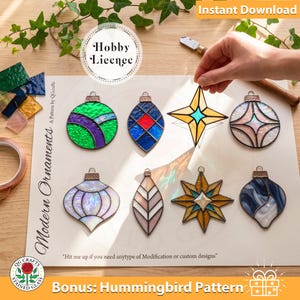 May include: A collection of eight stained glass ornaments in various shapes and colors, including circular, star, and teardrop designs. The ornaments are displayed on a printed pattern sheet titled Modern Ornaments with the text Hobby Licence.