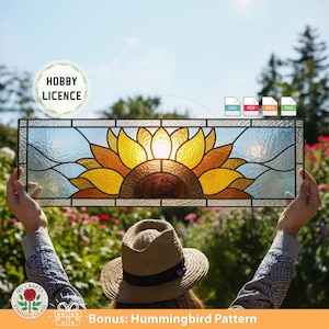 May include: A rectangular stained glass panel featuring a sunflower design with yellow, orange, and brown petals. The panel has a clear, textured background and is framed with black lines. The image includes the text "Hobby Licence" and "Bonus: Hummingbird Pattern".