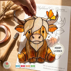 May include: A stained glass Highland cow with a butterfly accent. The cow is primarily shades of brown and tan, with black eyes and a white face. The image includes the text "Highland Cow Pattern" and "Hobby Licence".