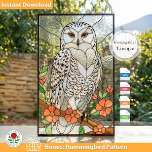 May include: Stained glass panel featuring a snowy owl perched on a branch with orange flowers. The owl has white and black patterned feathers and yellow eyes. The panel is framed in black and includes the text "Instant Download" and "Bonus: Hummingbird Pattern".