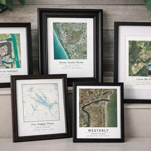 May include: Five framed aerial map prints. The prints feature various locations with text such as "We're From Nokomis", "Home Sweet Home", "Casa de Vore", "Our Happy Place", and "Westerly". The frames are black and brown.