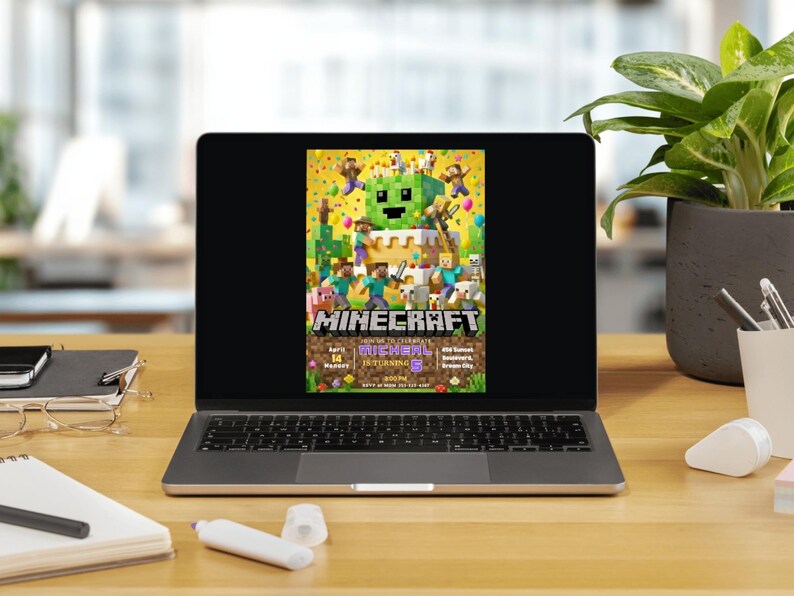 May include: A laptop displays a colorful Minecraft-themed birthday party invitation. The invitation features pixelated characters, a cake, and the game's logo. The screen is set on a wooden desk with office supplies and a potted plant.
