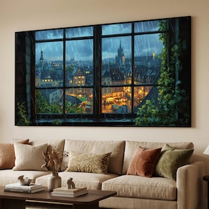 Peut inclure: Impression sur toile encadrée représentant une ville européenne sous la pluie, vue à travers une fenêtre. L'œuvre montre une ville avec des bâtiments éclairés, un clocher et de la pluie. Le feuillage vert encadre la fenêtre, ajoutant une touche naturelle.
