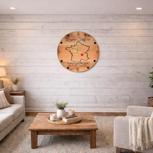 May include: A round wooden clock featuring a map of France, the text "Bryanne Stafford", and "France Lyon Mission March 2021 - Sept 2022". The clock is mounted on a white wood-panelled wall.