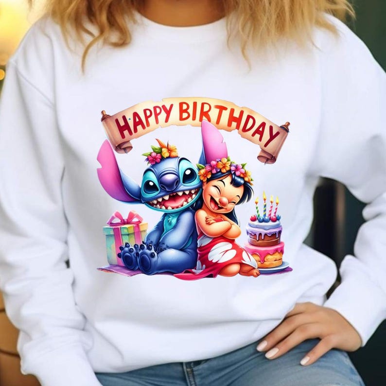May include: White sweatshirt featuring a colorful graphic of Stitch and Lilo from Lilo & Stitch, with a banner that reads "Happy Birthday." The design includes a birthday cake and wrapped gifts.