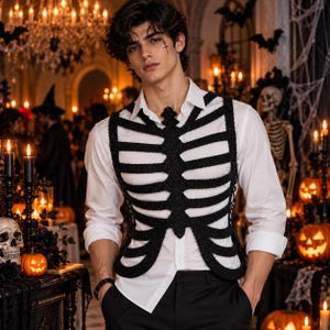May include: A black crocheted vest featuring a rib cage design worn over a crisp white long-sleeved button-down shirt and black trousers. The vest is constructed with thick yarn forming the sternum and horizontal rib bones across the chest.