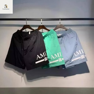 Pantaloncini da bagno con stampa logo Amiri // Costumi da bagno streetwear di lusso