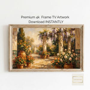 May include: A framed digital artwork depicting a sunlit garden scene with potted flowers, wisteria, and stone columns. The artwork is in warm tones of orange, beige, and green. Text at the top reads "Premium 4k Frame TV Artwork Download INSTANTLY."