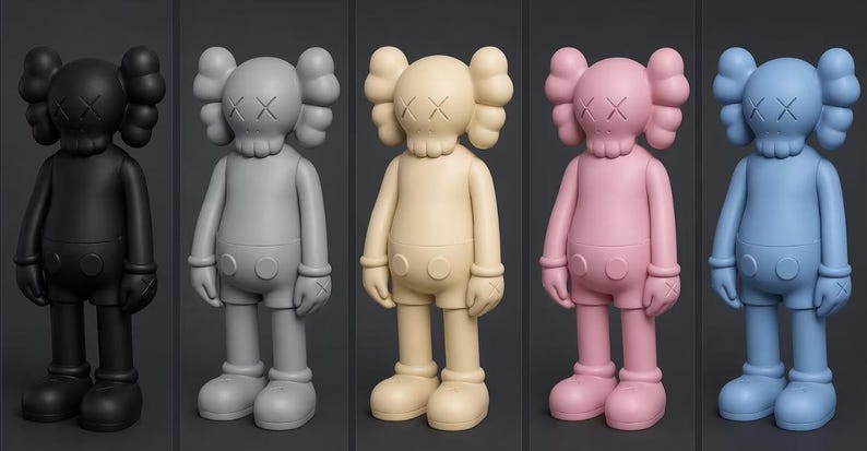 May include: Five colorful vinyl figures in black, gray, cream, pink, and blue. Each figure has a distinctive skull-like head with crossed-out eyes and rounded ears. They are posed standing with arms at their sides.