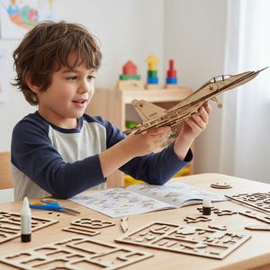 May include: A wooden model aeroplane kit with a young person holding the assembled plane. The kit includes pre-cut wooden pieces, glue, and instructions. The plane features a detailed design with red star markings.